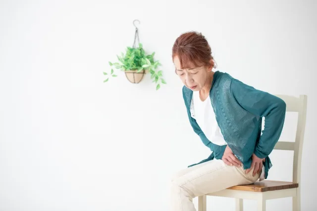 太ももの痛みを感じる女性