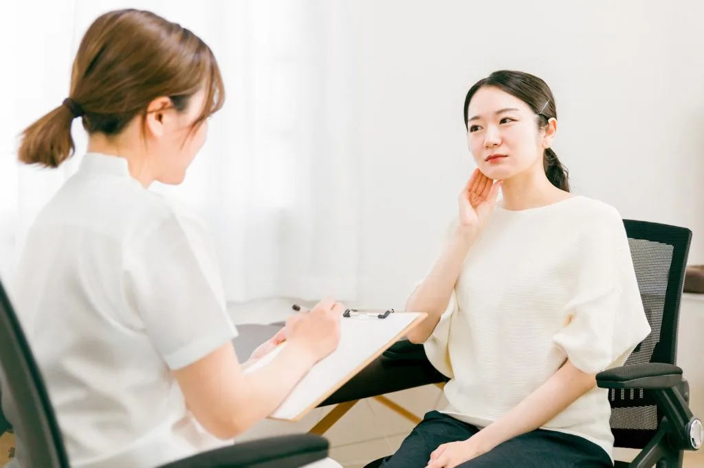 整体で問診を受ける女性