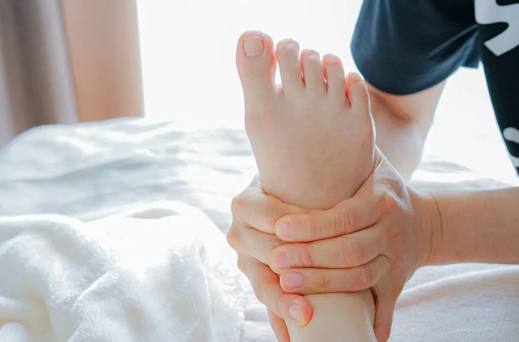 足の裏のツボを両手で押されている様子