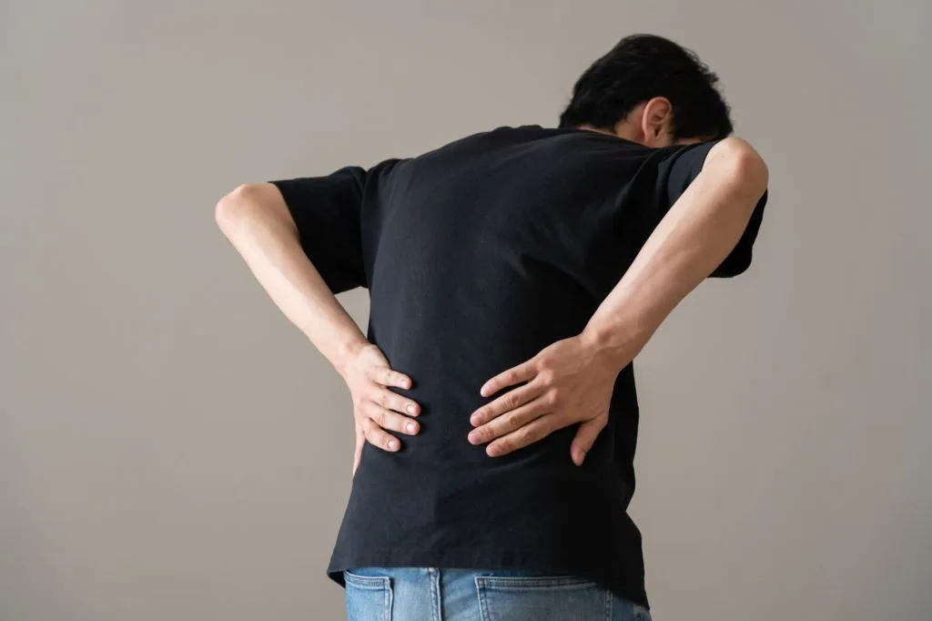 両手で腰を押さえる男性