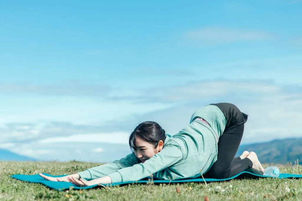 外でストレッチをする女性